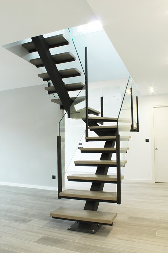 Escalera modelo “Burgos”:  de zanca central con barandilla de vidrio.